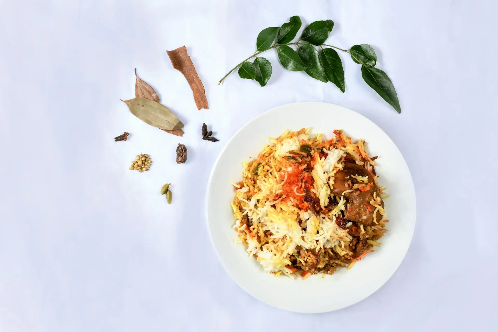 white ceramic plate with rice and green leaves