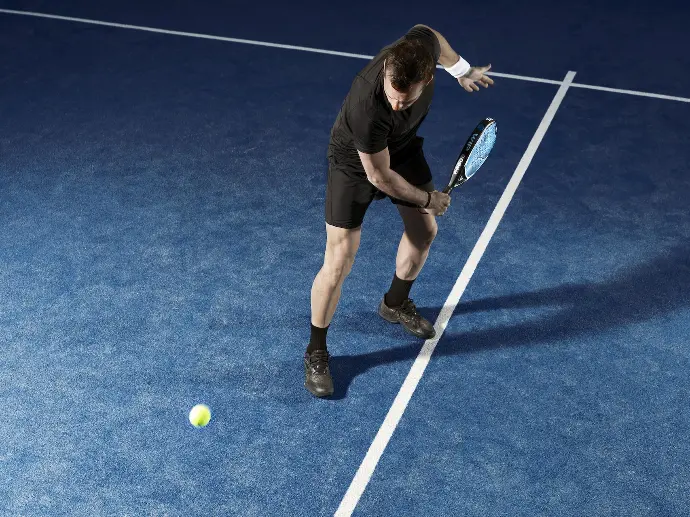 a man holding a tennis racquet on a tennis court